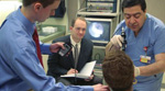 Case Western Reserve, Prof. Dustin Tyler(center), graduate student Aaron Haldey(left), and physician collaborator Michael Broniatowski, M.D., F.A.C.S. use electrical stimulation of nerves in the subject's neck to improve swallowing following stroke or other central nervous system disorder, 2009